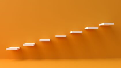 orange wall and floor with white shelves hung as steps going upward